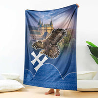 Blue blanket with eagle swooping over castle scene, white cross and geometric Slovak pattern