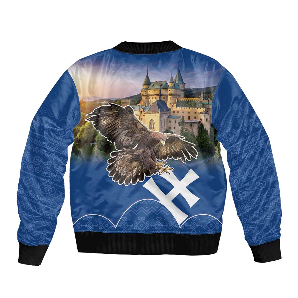 Blue bomber jacket back view with eagle graphic over castle, Slovak cross flag