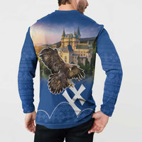 Blue button-up sweatshirt worn by a man, showing back eagle and castle graphic