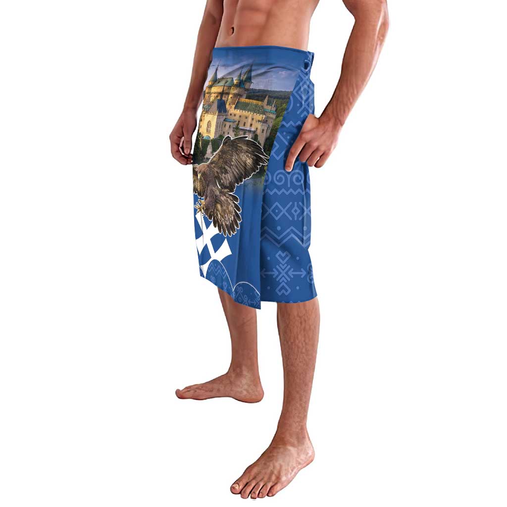 Blue lavalava with eagle over castle graphic and Aztec-like geometric border