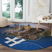 Round blue area rug with large brown eagle over castle image and white cross motifs