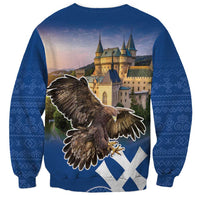 Blue unisex sweatshirt with eagle and castle graphic on back, diamond pattern
