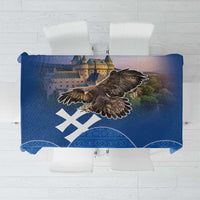 Blue tablecloth with eagle and castle graphic and white geometric pattern border