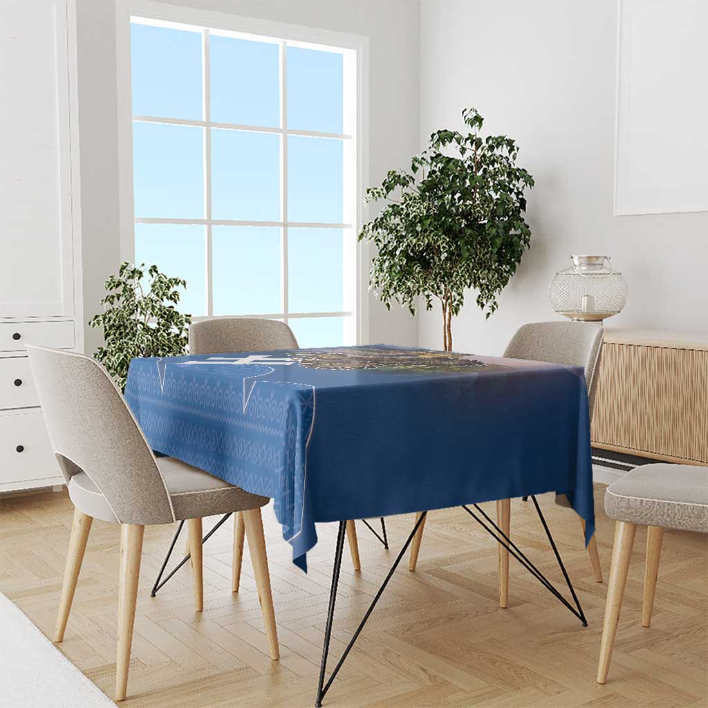 Blue tablecloth draped on dining table with matching white geometric pattern