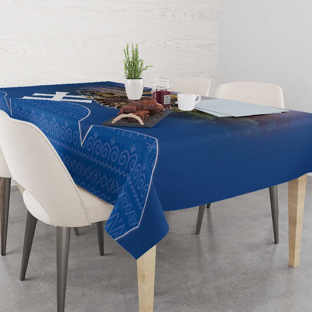 Blue tablecloth with repeating folk-style pattern along table edge