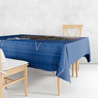 Blue tablecloth corner drape with folk pattern and small emblem graphic