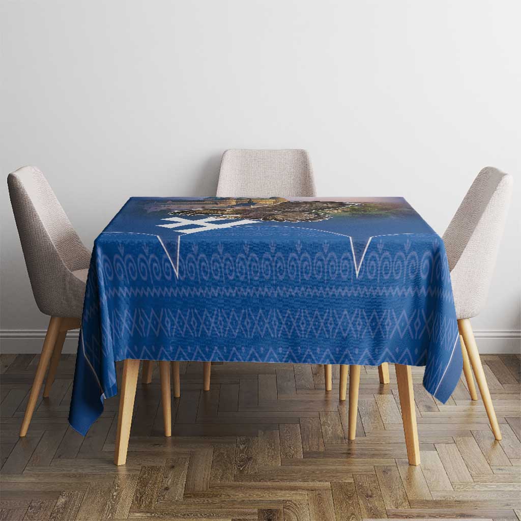 Blue patterned tablecloth on dining table with four chairs around