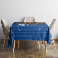 Blue patterned tablecloth on dining table with four chairs around