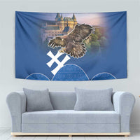 Blue wall tapestry with eagle in flight, castle artwork, and white cross over blue arches