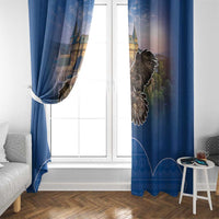 Blue window curtain pair with castle-and-eagle print, hanging to either side of glass door