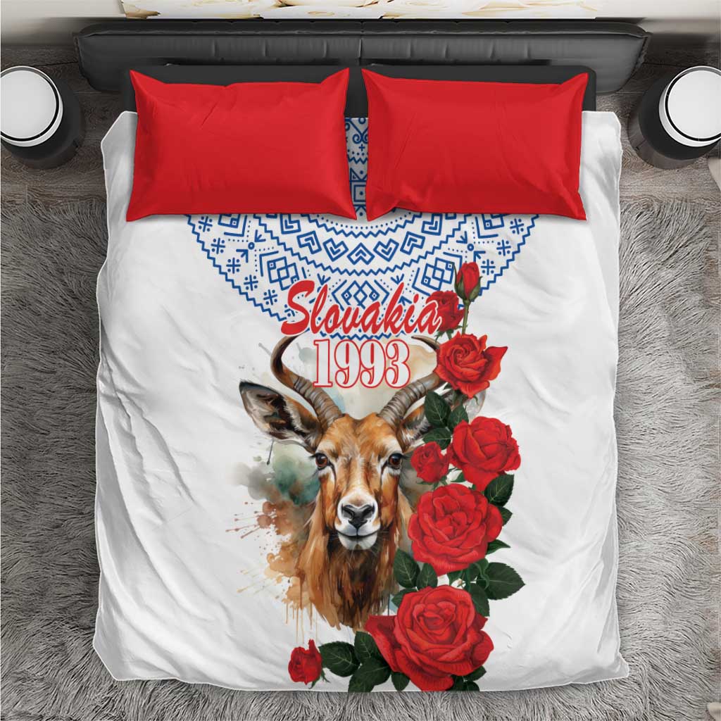 White bedding set with blue geometric trim, chamois graphic, red roses, and red pillowcases