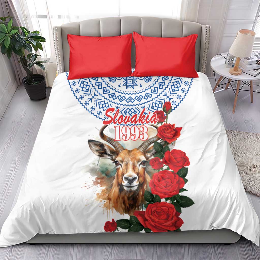 White duvet cover with blue pattern, chamois portrait, red roses, and two red square pillowcases