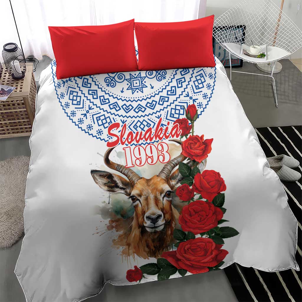 White bedding set featuring blue geometric band, chamois illustration, red roses, and red pillowcases