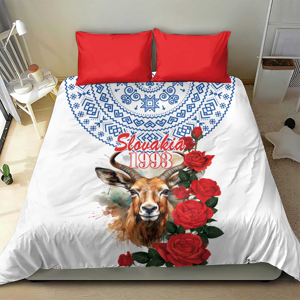 White duvet and red pillowcases with blue motif, chamois graphic, and red rose bouquet design
