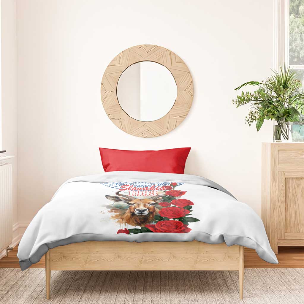 White bedding set with red rose and chamois graphic, blue geometric detail, no visible pillowcases