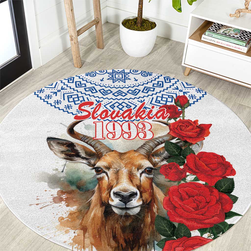 Round white area rug with Tatra deer face, blue pattern border, Slovakia 1993 text, red roses
