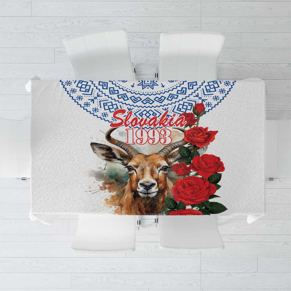 White tablecloth with blue geometric border and red rose and Slovakia 1993 design