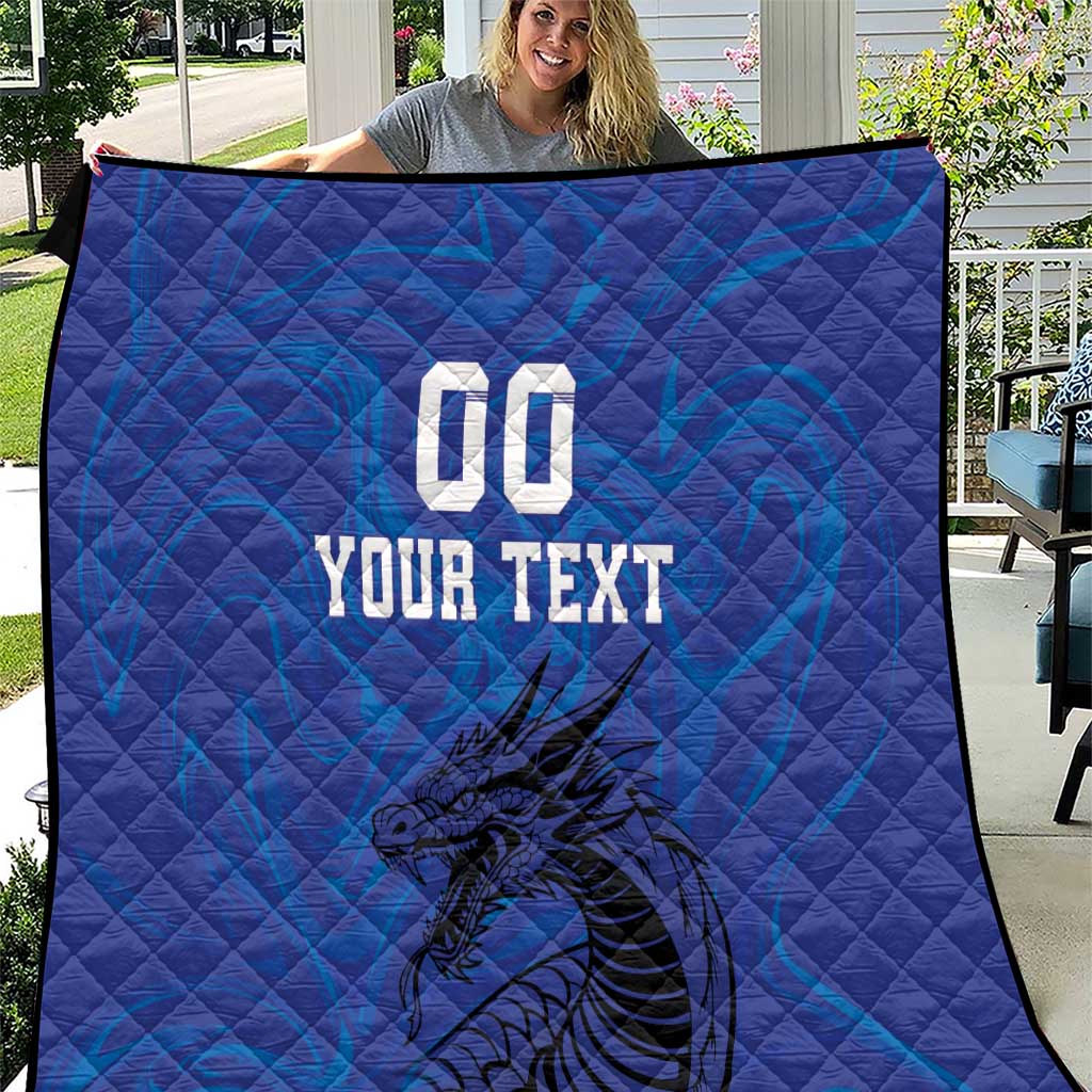 Blue quilt blanket with dragon artwork and bold “YOUR TEXT” print in the center.