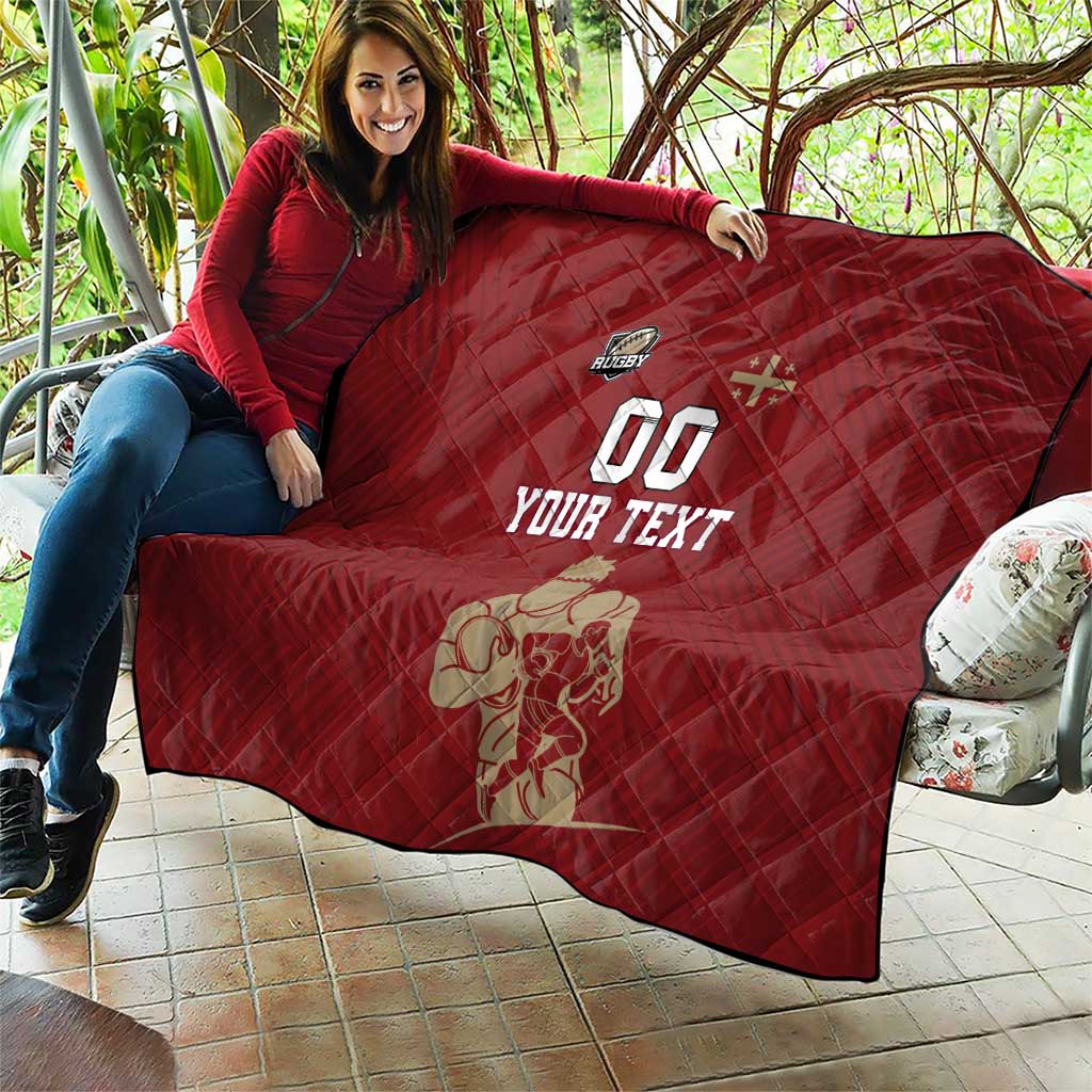 Red quilt draped on a person’s lap outdoors, diamond stitching and rugby '00' 'YOUR TEXT'