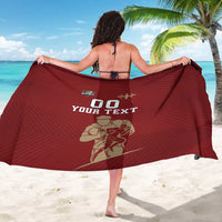 Red rugby sarong with '00 YOUR TEXT' rugby player graphic, worn as open wrap