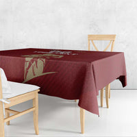 Red rugby tablecloth with gold emblem artwork draped over a bench table