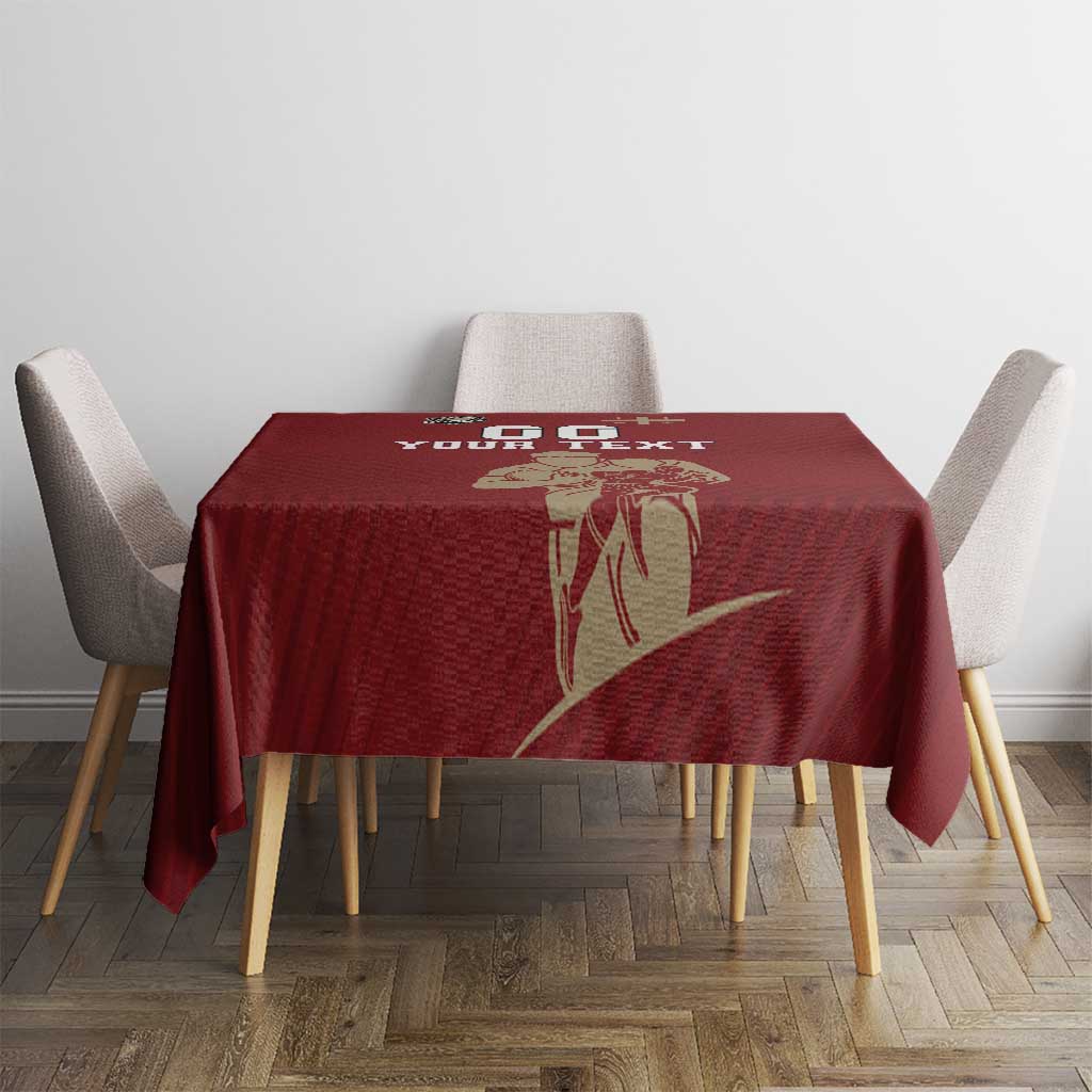Red rugby tablecloth with gold emblem and “YOUR TEXT” over dining table