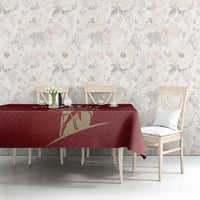 Red rugby tablecloth with gold shield graphic and bird-like emblem center