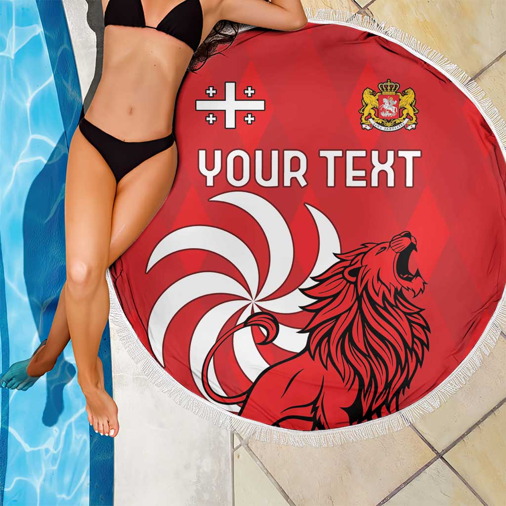 Red round beach blanket with fringe, lion graphic and “YOUR TEXT” print, beside pool
