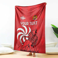 Red personalized Georgia blanket draped, showing lion graphic and "Your Text" on front