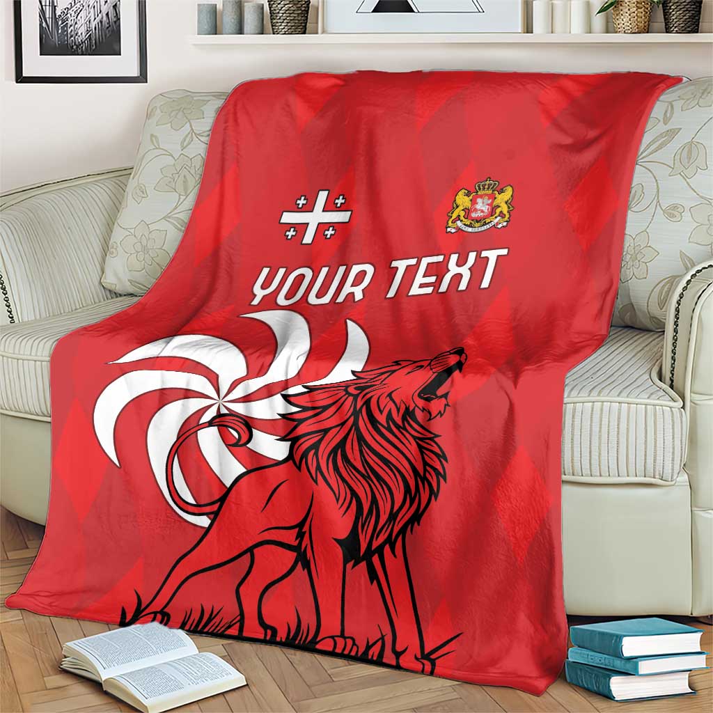 Red personalized Georgia blanket on a couch featuring lion emblem and "Your Text"