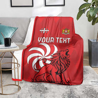 Red personalized Georgia blanket on a sofa with lion illustration and "Your Text" panel