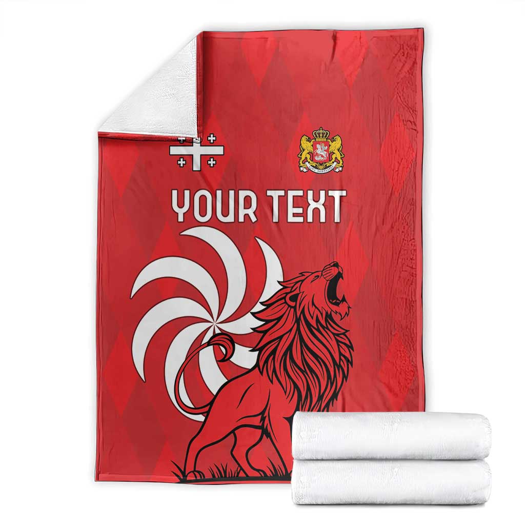 Red personalized Georgia blanket with lion design and "Your Text", folded with white rolls