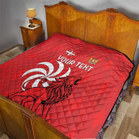 Red quilt on a bed with diamond quilting, lion emblem, and “YOUR TEXT”