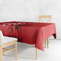 Red tablecloth with lion graphic and side drape on dining table