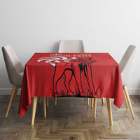 Red tablecloth with lion illustration over square dining table