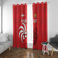 Red window curtain pair with lion crest and “TEXT” design, curtains pulled open