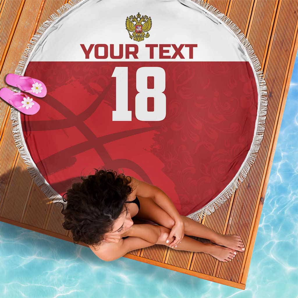 Red round beach blanket with white fringe, crest, custom text and number 18 shown at angle