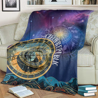 Purple space blanket featuring gold astronomical clock dial and Czech Republic text on couch