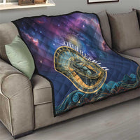 Purple and blue quilt on sofa showing gold astronomical clock emblem and wave trim at bottom
