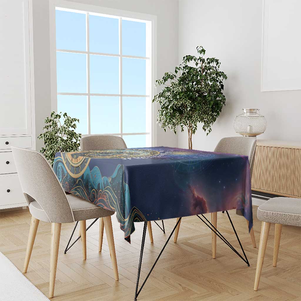 Purple space tablecloth draped over dining table, gold zodiac wheel and galaxy print
