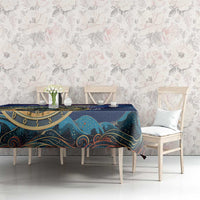 Purple astronomy tablecloth on table, gold zodiac ring with stars and teal wave details