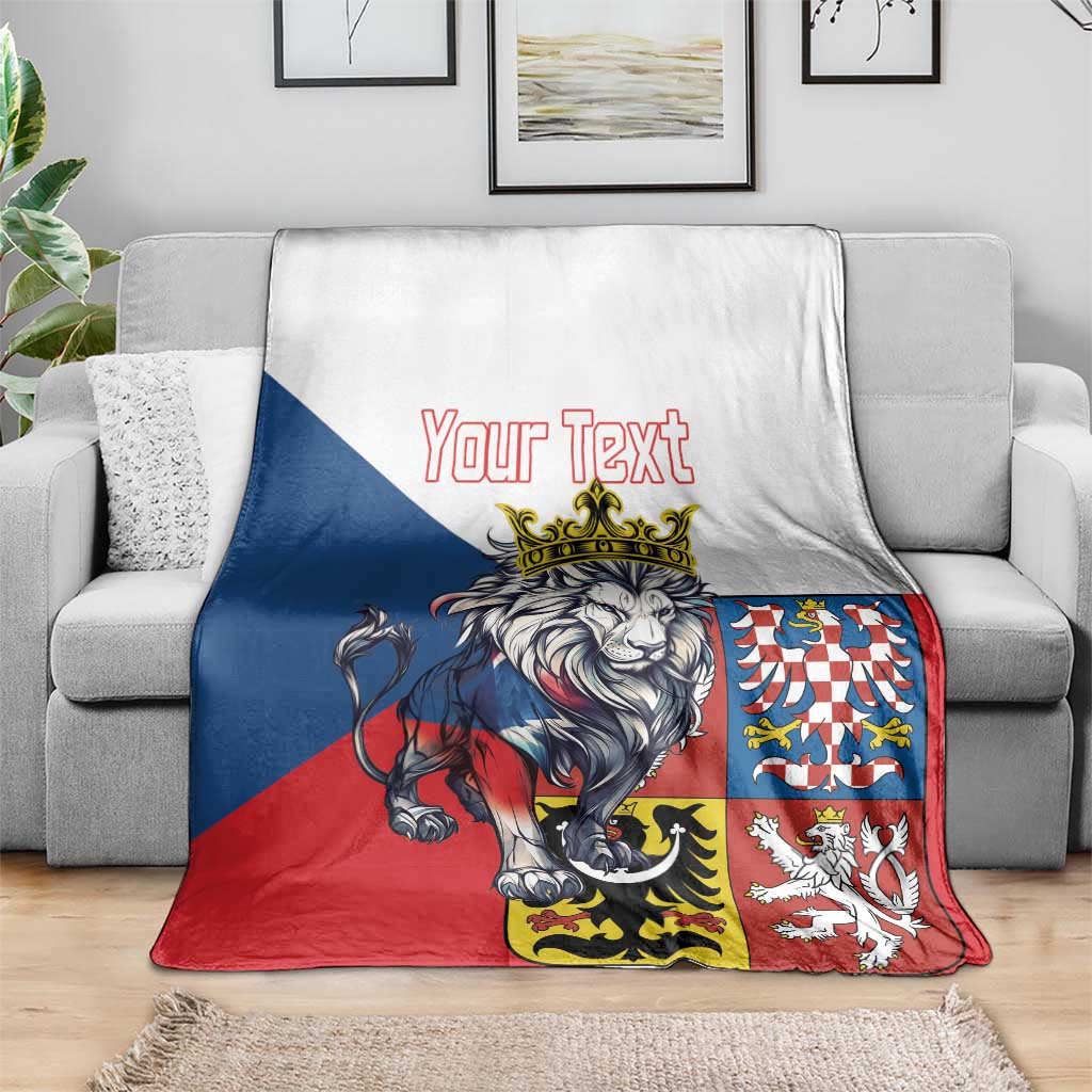 Personalized lion crest throw blanket on gray couch, showing “Your Text” centerpiece