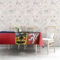 Red tablecloth with large lion crest and shield panel, draped over the tabletop corner