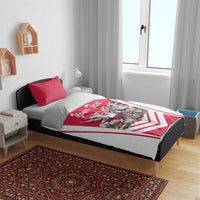 Red and white duvet set on bed with eagle graphic, city scene, and “Your Text” banner