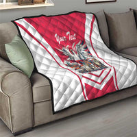 Red and white quilt on a sofa with eagle graphic, “Your Text” script, quilted pattern