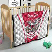 Red and white quilt on a crib with eagle crest, “Your Text” script, and diamond quilting