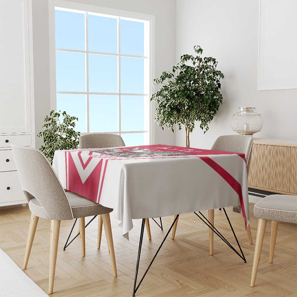 Red and white personalized tablecloth draped over dining table with bold chevron pattern