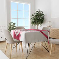 Red and white personalized tablecloth draped over dining table with bold chevron pattern