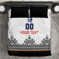 White duvet with blue crest, '00' and red 'YOUR TEXT', black Nordic stripe border, two black pillows