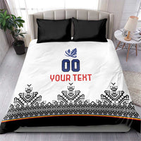 White bedding set with black Nordic trim, blue crest, '00' and red 'YOUR TEXT', black pillows